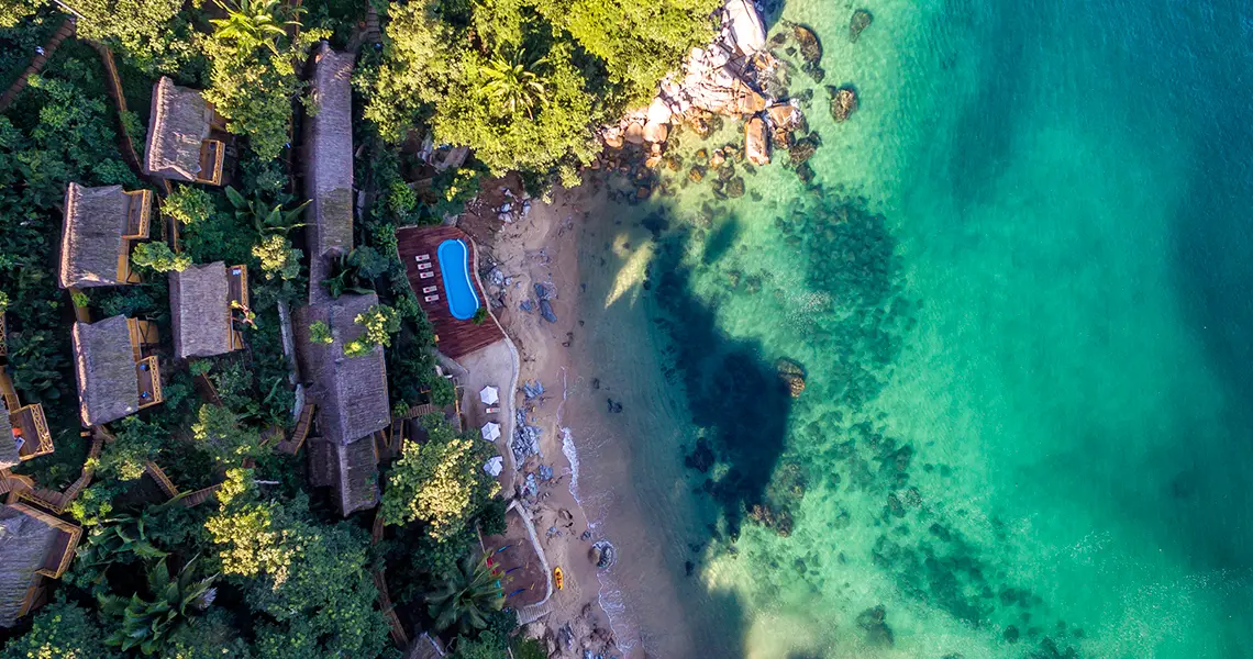 Aerial photo of Xinalani Retreat’s beachfront and infinity pool in Puerto Vallarta, Mexico.