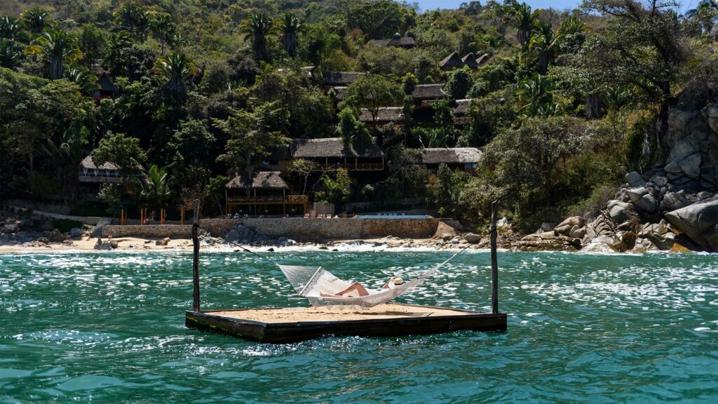 Ocean-view hammock on Xinalani's floating dock, a beachfront yoga retreat near Puerto Vallarta